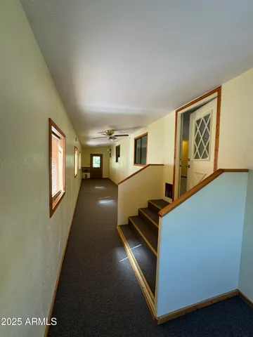 a room with furniture pool table and windows