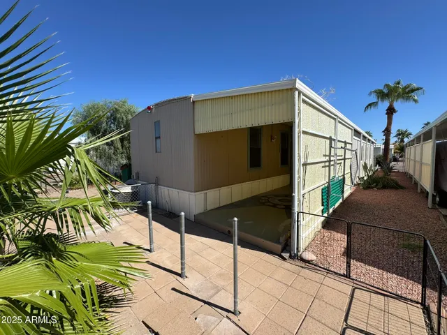 a backyard of a house with barbeque oven and outdoor seating