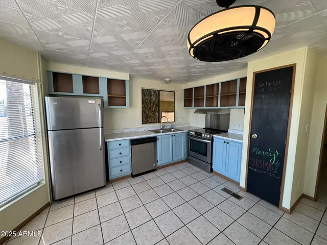a kitchen with stainless steel appliances granite countertop a refrigerator and a stove top oven