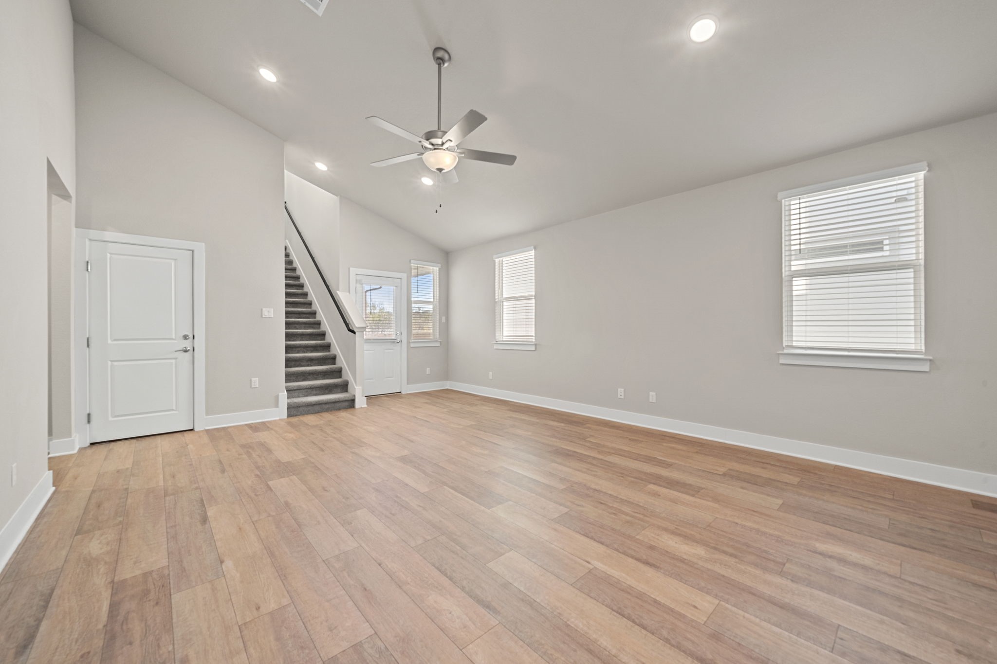 219 Pinnacle Lane Kyle, TX 78640 - Photo 16 of 20 a view of an empty room with wooden floor and a window
