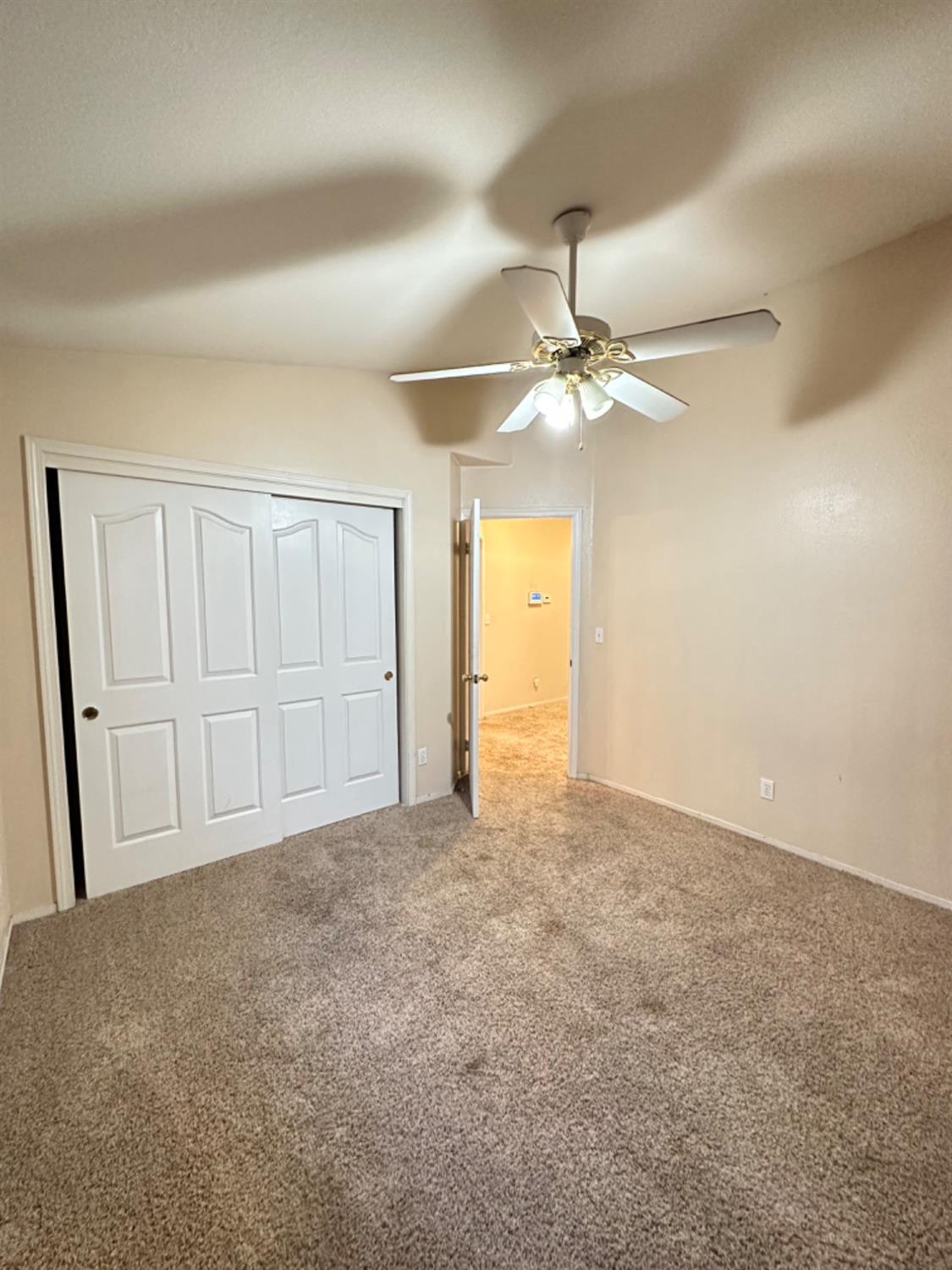 596 Grenache Avenue Madera, CA 93637 - Photo 12 of 26 a view of an empty room with a ceiling fan