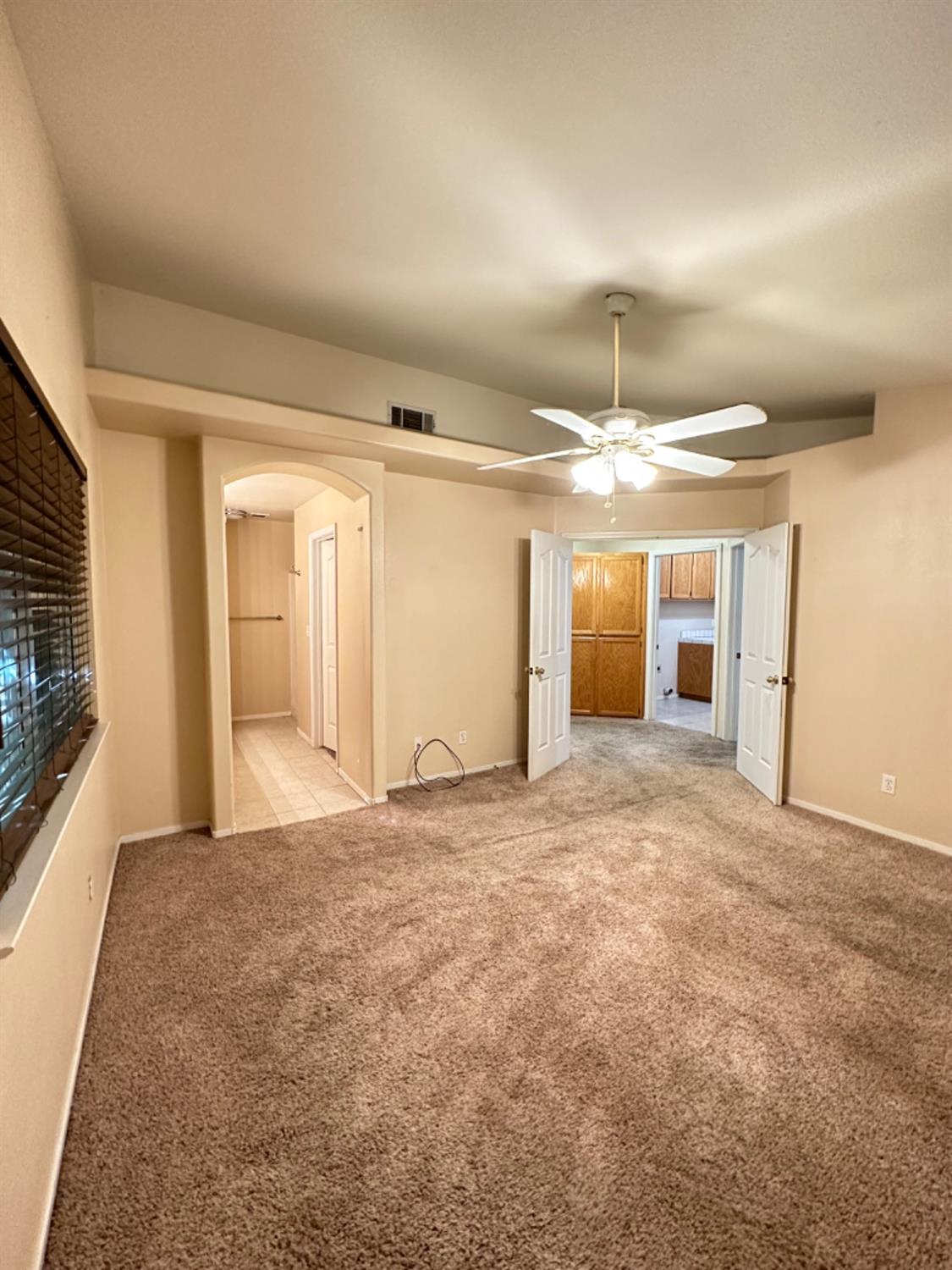 596 Grenache Avenue Madera, CA 93637 - Photo 16 of 26 a view of an empty room with window and chandelier