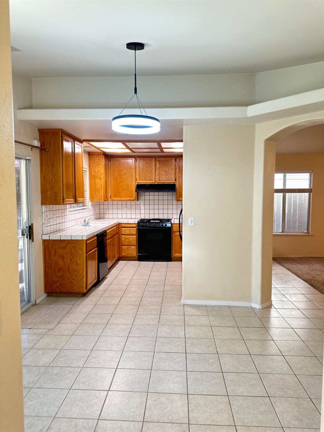 596 Grenache Avenue Madera, CA 93637 - Photo 2 of 26 a large kitchen with stainless steel appliances a stove a sink and a refrigerator