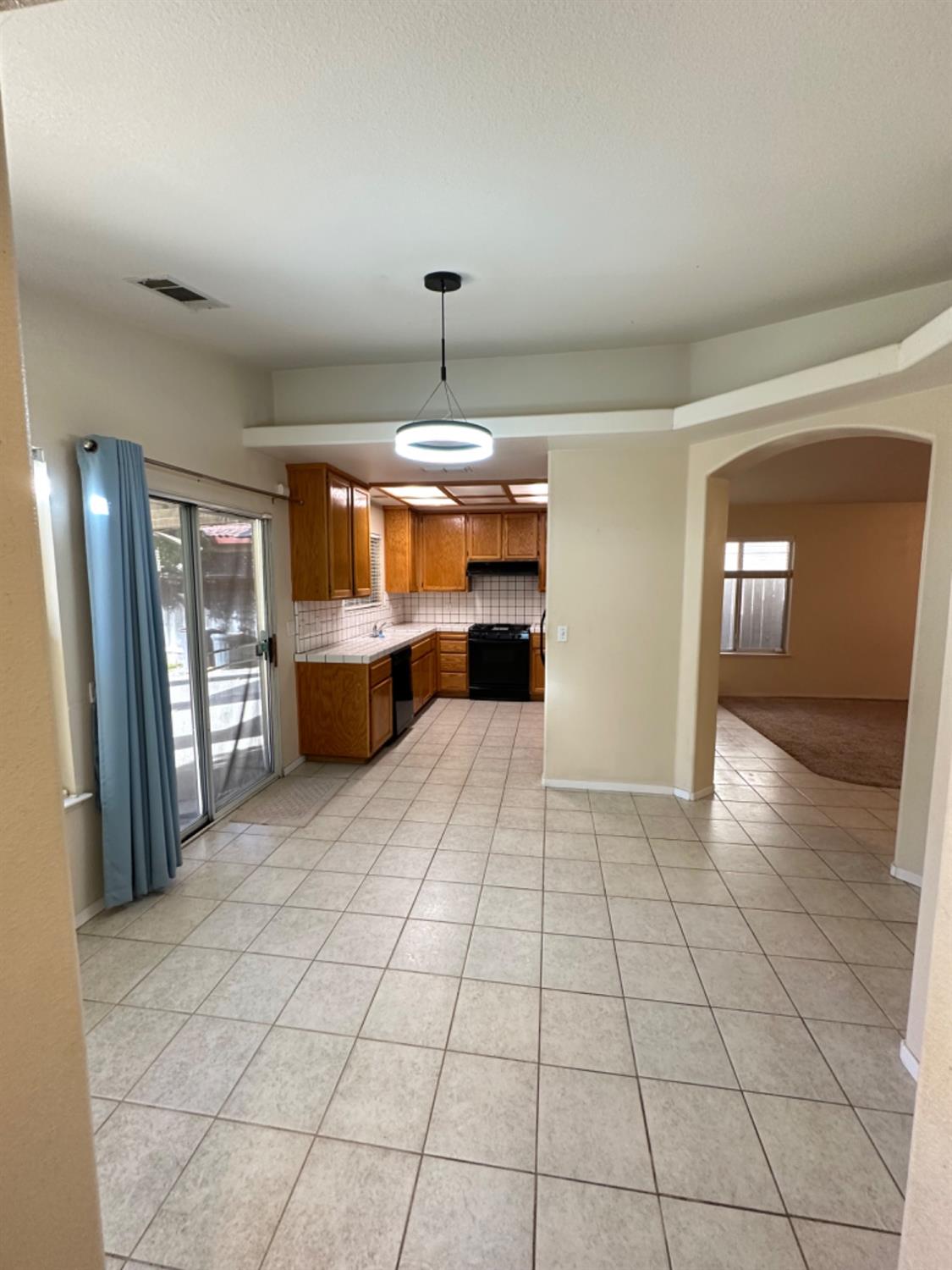 596 Grenache Avenue Madera, CA 93637 - Photo 3 of 26 a room with lots of furniture and a chandelier