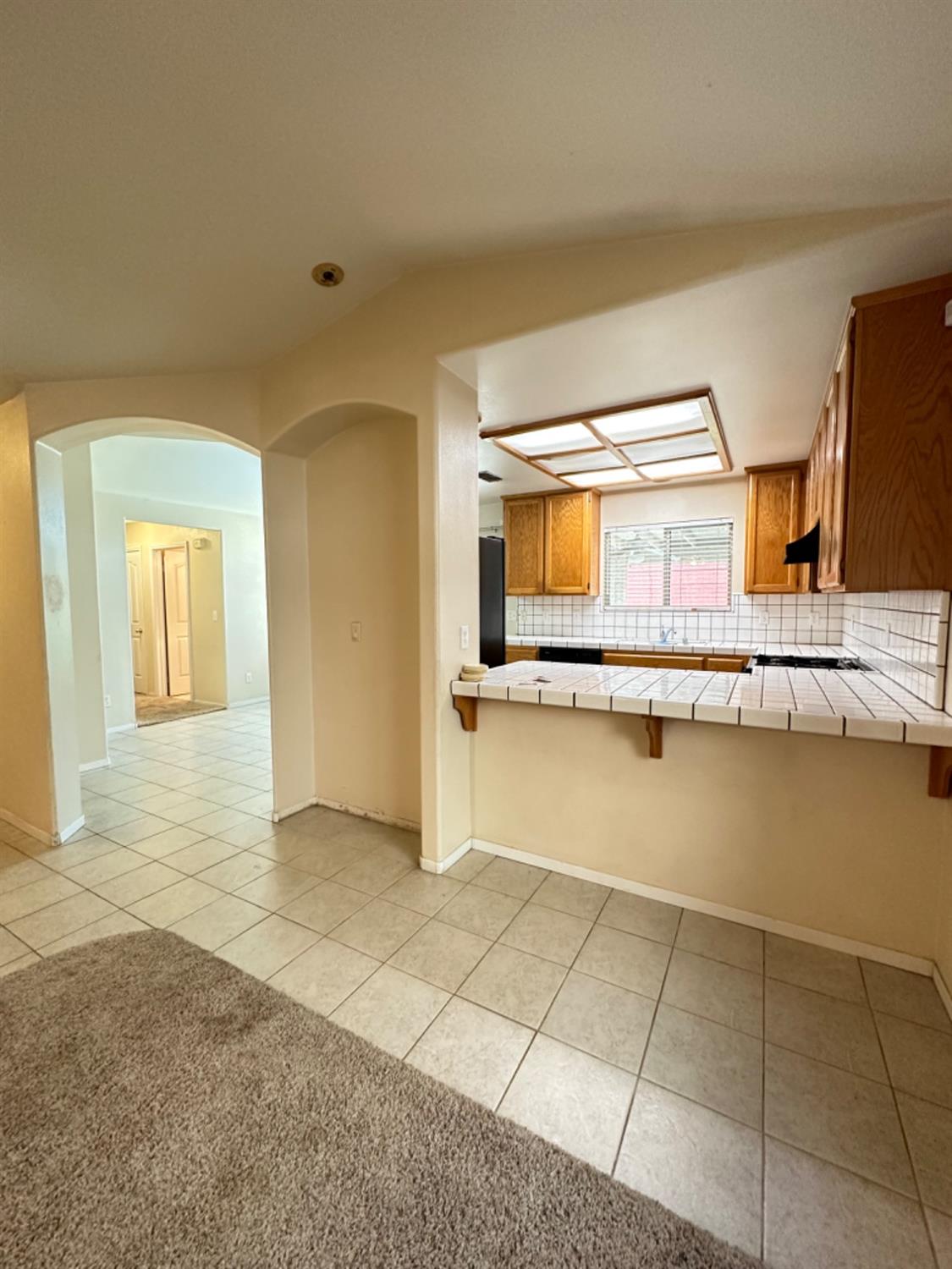596 Grenache Avenue Madera, CA 93637 - Photo 7 of 26 a view of a kitchen with stainless steel appliances a sink and cabinets