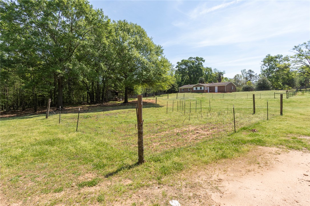 820 Travis Road Anderson, SC 29626 - Photo 43 of 46 Expansive green yard with fencing offers open space and a peaceful atmosphere.