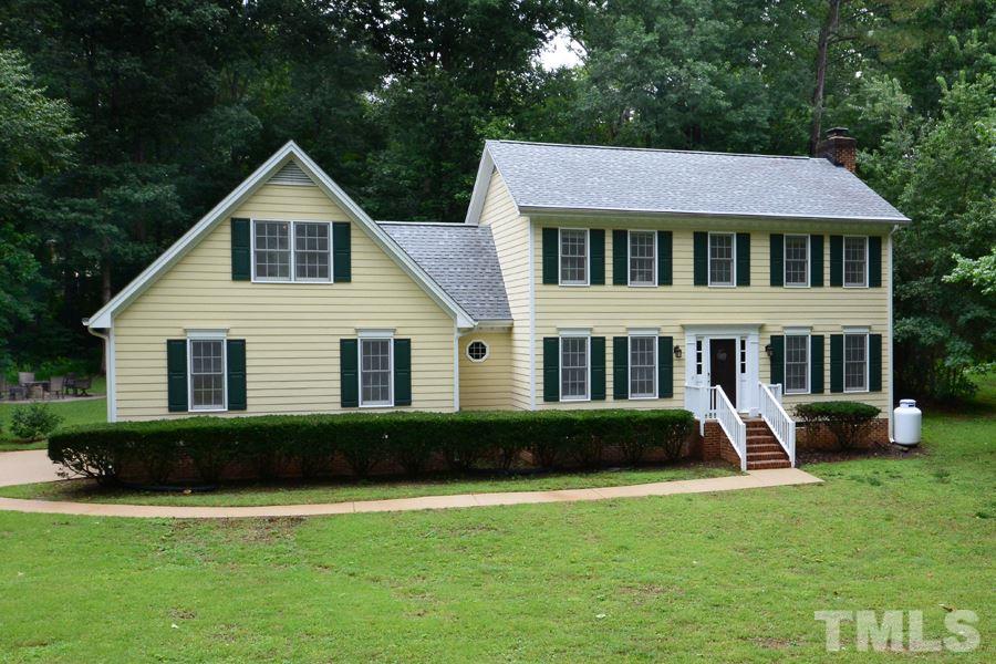 6013 Hampton Ridge Road Raleigh, NC 27603 - Photo 1 of 25 a front view of a house with garden