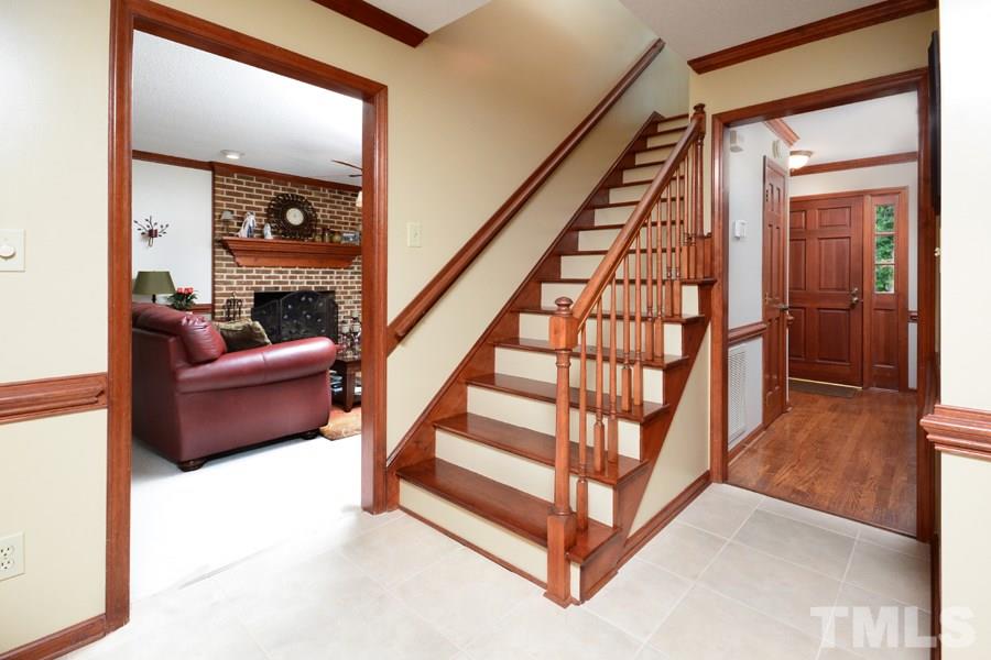 6013 Hampton Ridge Road Raleigh, NC 27603 - Photo 11 of 25 a view of staircase with white walls and a rug