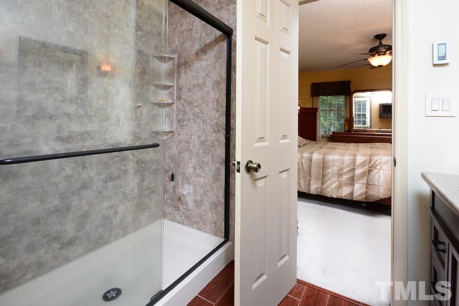 6013 Hampton Ridge Road Raleigh, NC 27603 - Photo 14 of 25 a bathroom with a tub and a double vanity sink