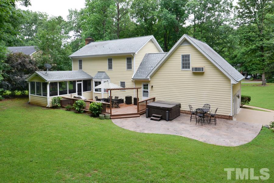 6013 Hampton Ridge Road Raleigh, NC 27603 - Photo 22 of 25 a view of a house with backyard sitting area and garden