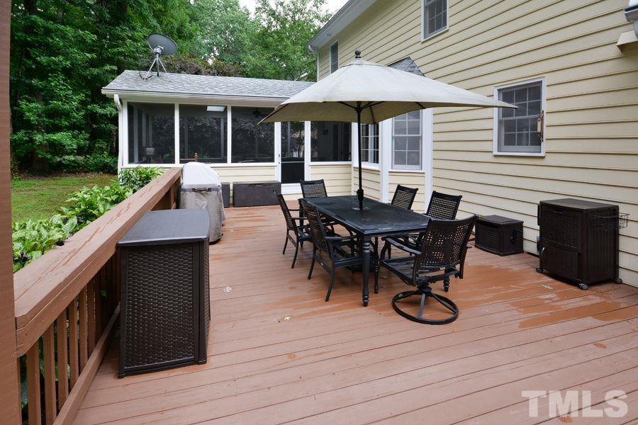 6013 Hampton Ridge Road Raleigh, NC 27603 - Photo 23 of 25 a view of a house with wooden deck and furniture