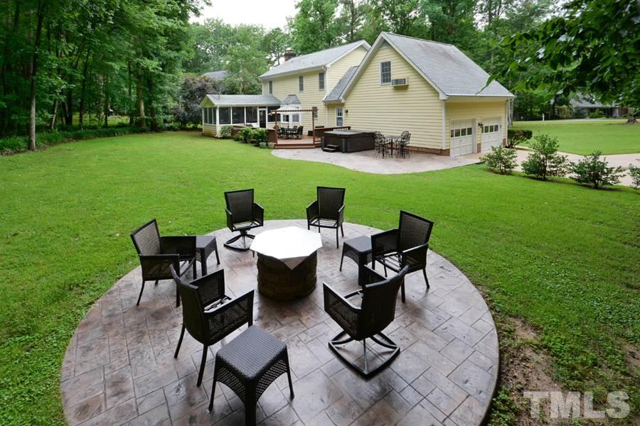 6013 Hampton Ridge Road Raleigh, NC 27603 - Photo 24 of 25 a view of a house with backyard sitting area and garden