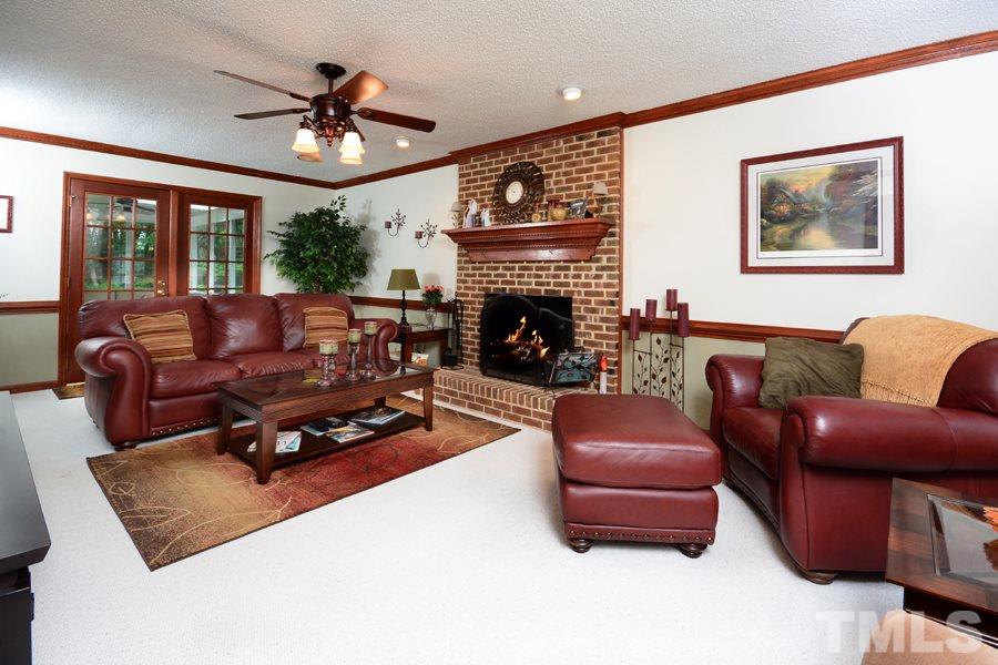 6013 Hampton Ridge Road Raleigh, NC 27603 - Photo 4 of 25 a living room with furniture and a fireplace