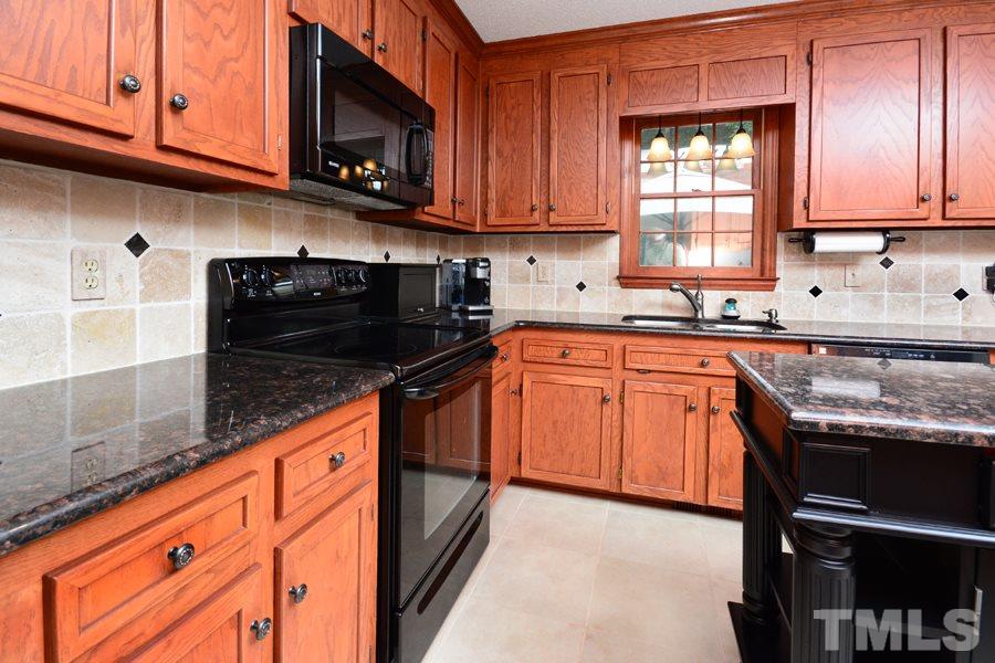 6013 Hampton Ridge Road Raleigh, NC 27603 - Photo 8 of 25 a kitchen with stainless steel appliances granite countertop a sink stove and microwave
