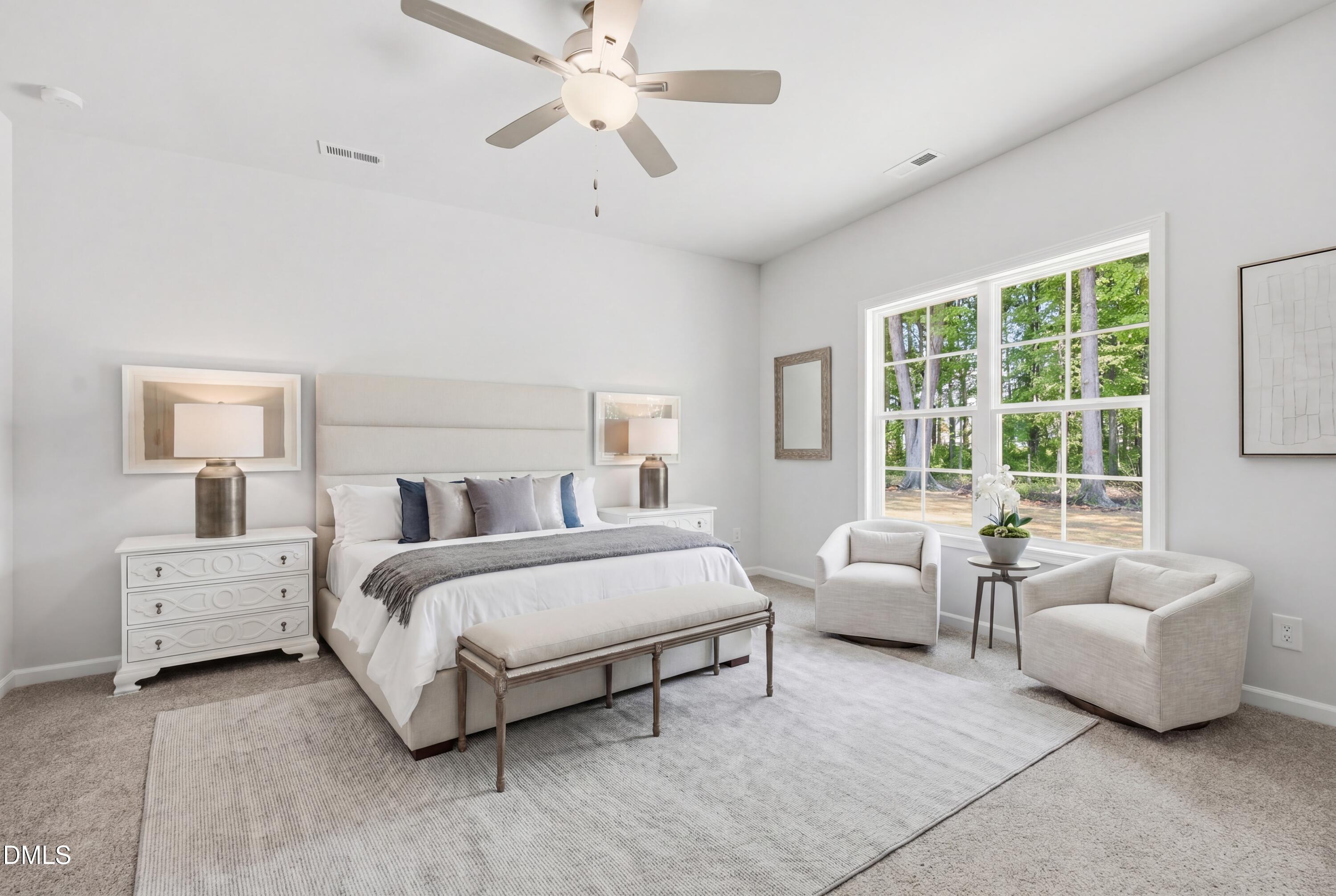 191 Nectar Lane Bunnlevel, NC 28323 - Photo 21 of 35 a spacious bedroom with a bed and a couch