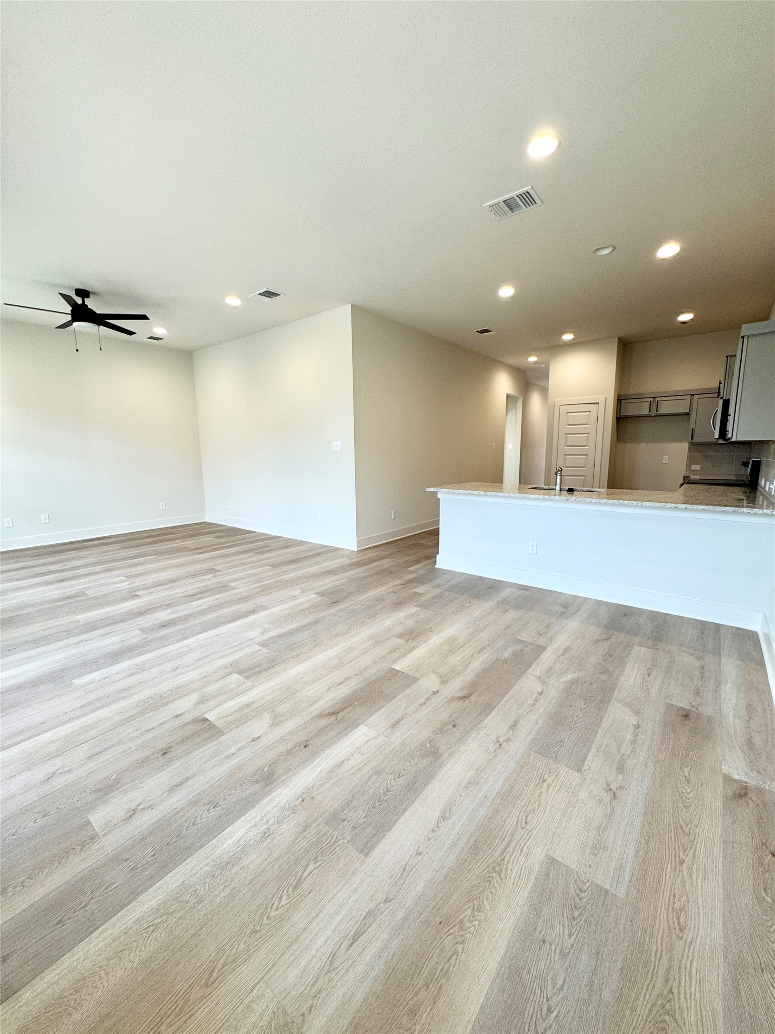 100 Zayd Court, Unit A Jarrell, TX 76537 - Photo 13 of 20 an empty room with wooden floor and windows