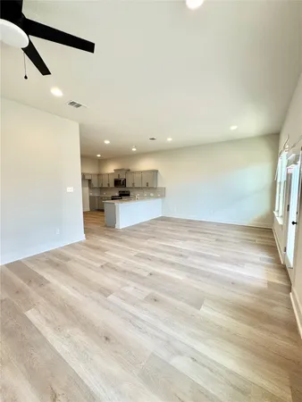 a large kitchen with kitchen island a sink stainless steel appliances and cabinets