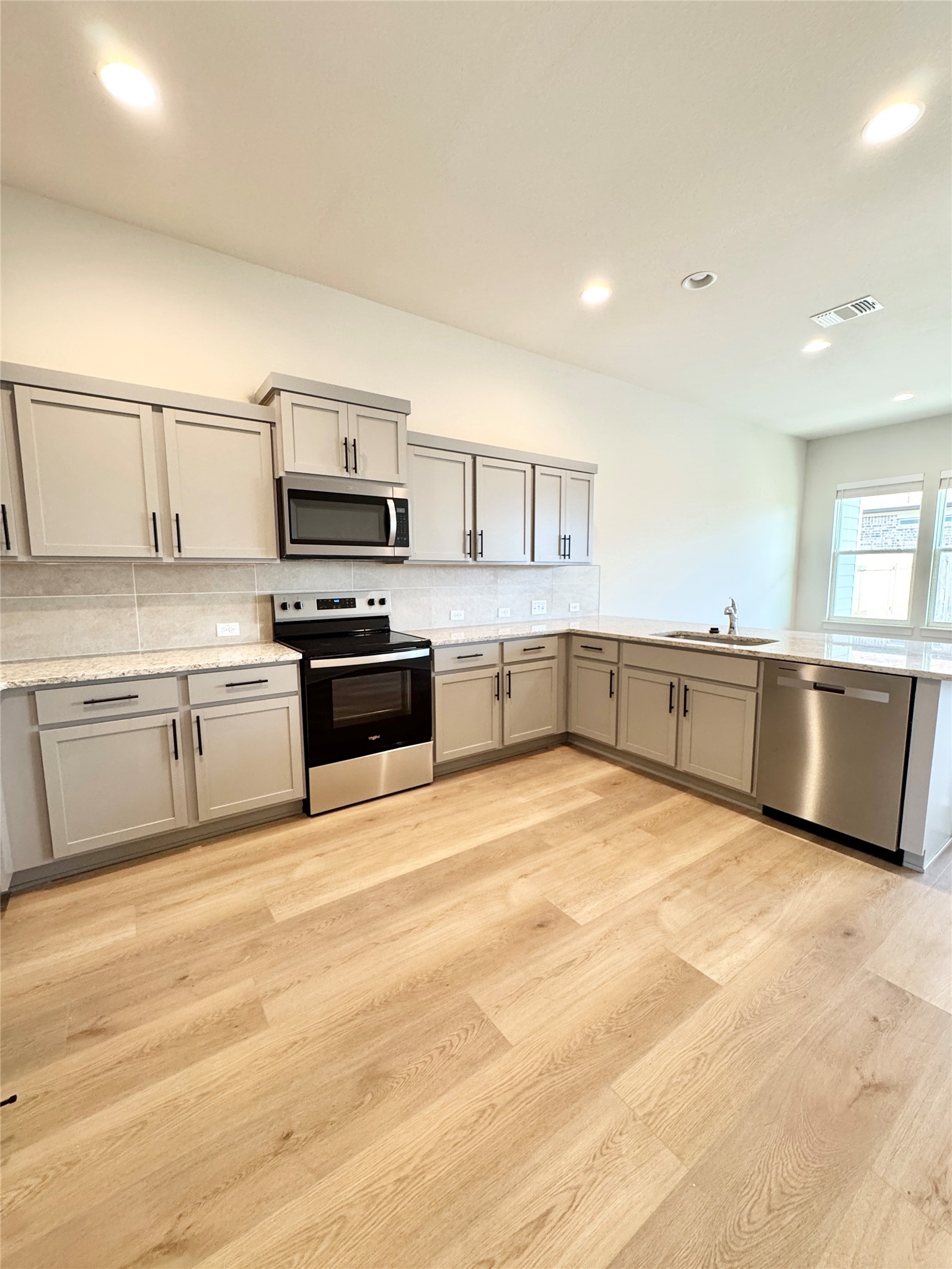 100 Zayd Court, Unit A Jarrell, TX 76537 - Photo 2 of 20 a large kitchen with cabinets and stainless steel appliances