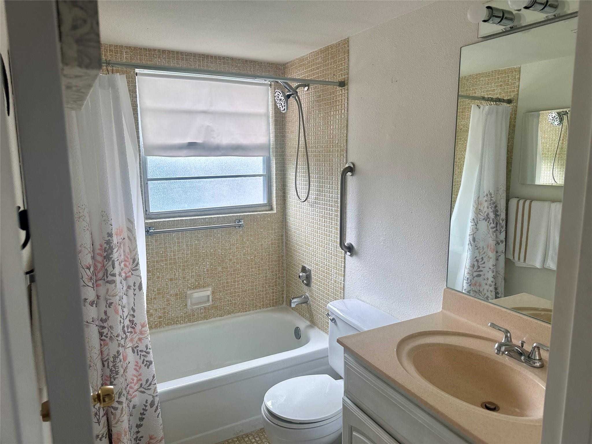 200 Mansfield F, Unit 200 Boca Raton, FL 33434 - Photo 13 of 15 a bathroom with a sink toilet and shower