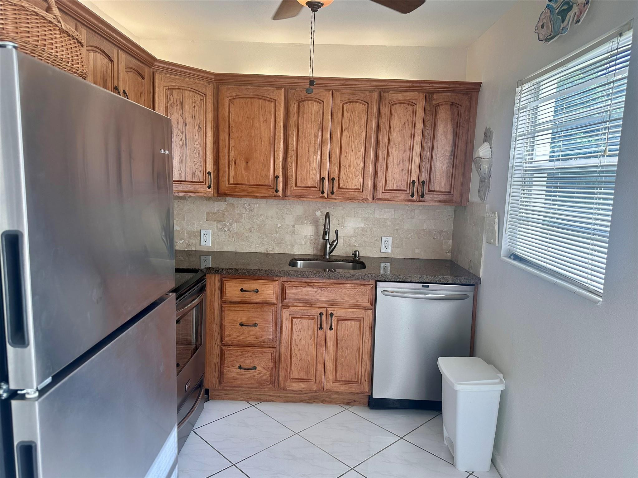 200 Mansfield F, Unit 200 Boca Raton, FL 33434 - Photo 2 of 15 a kitchen with stainless steel appliances granite countertop a refrigerator sink and cabinets