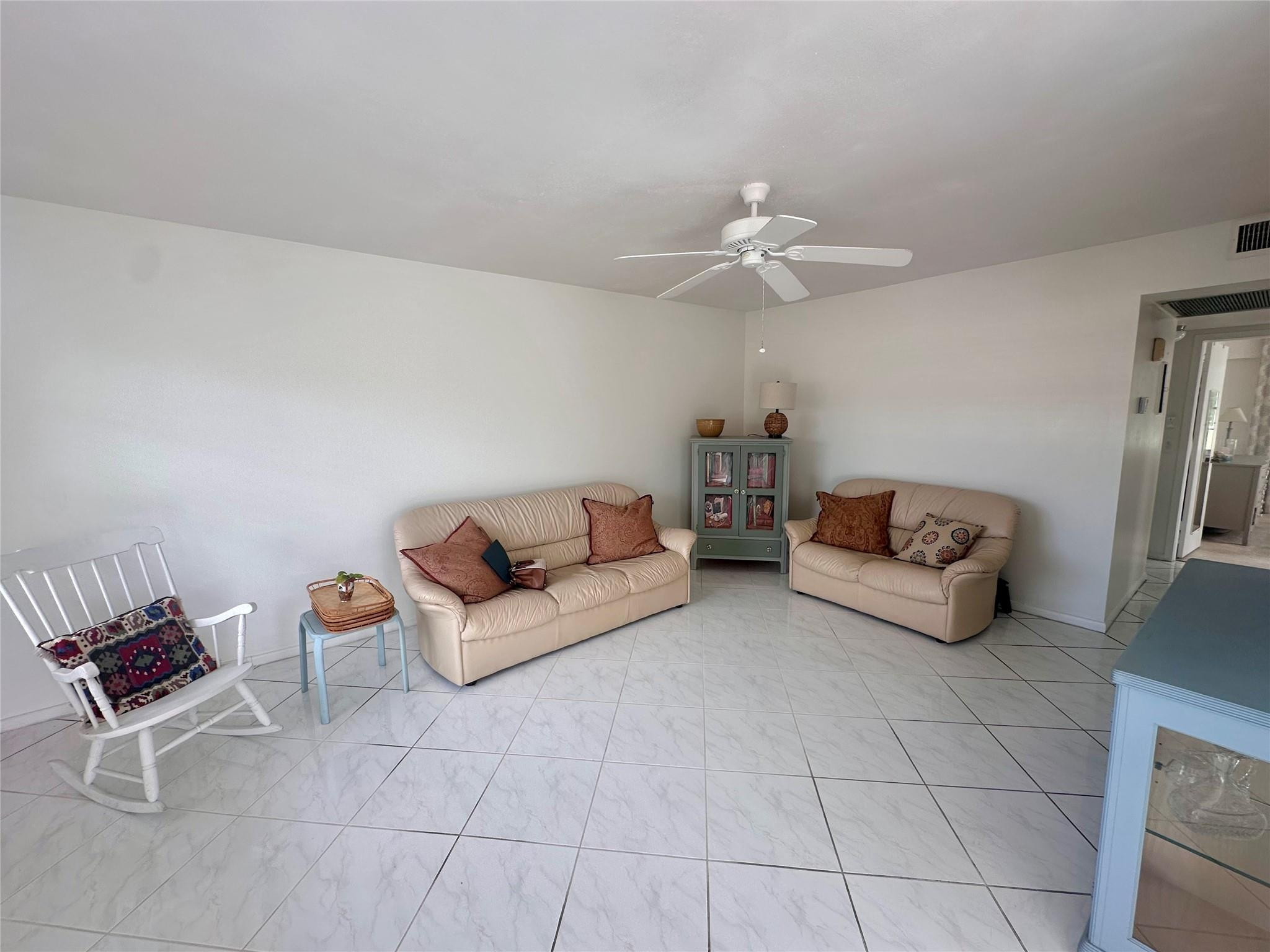 200 Mansfield F, Unit 200 Boca Raton, FL 33434 - Photo 5 of 15 a living room with furniture and a ceiling fan