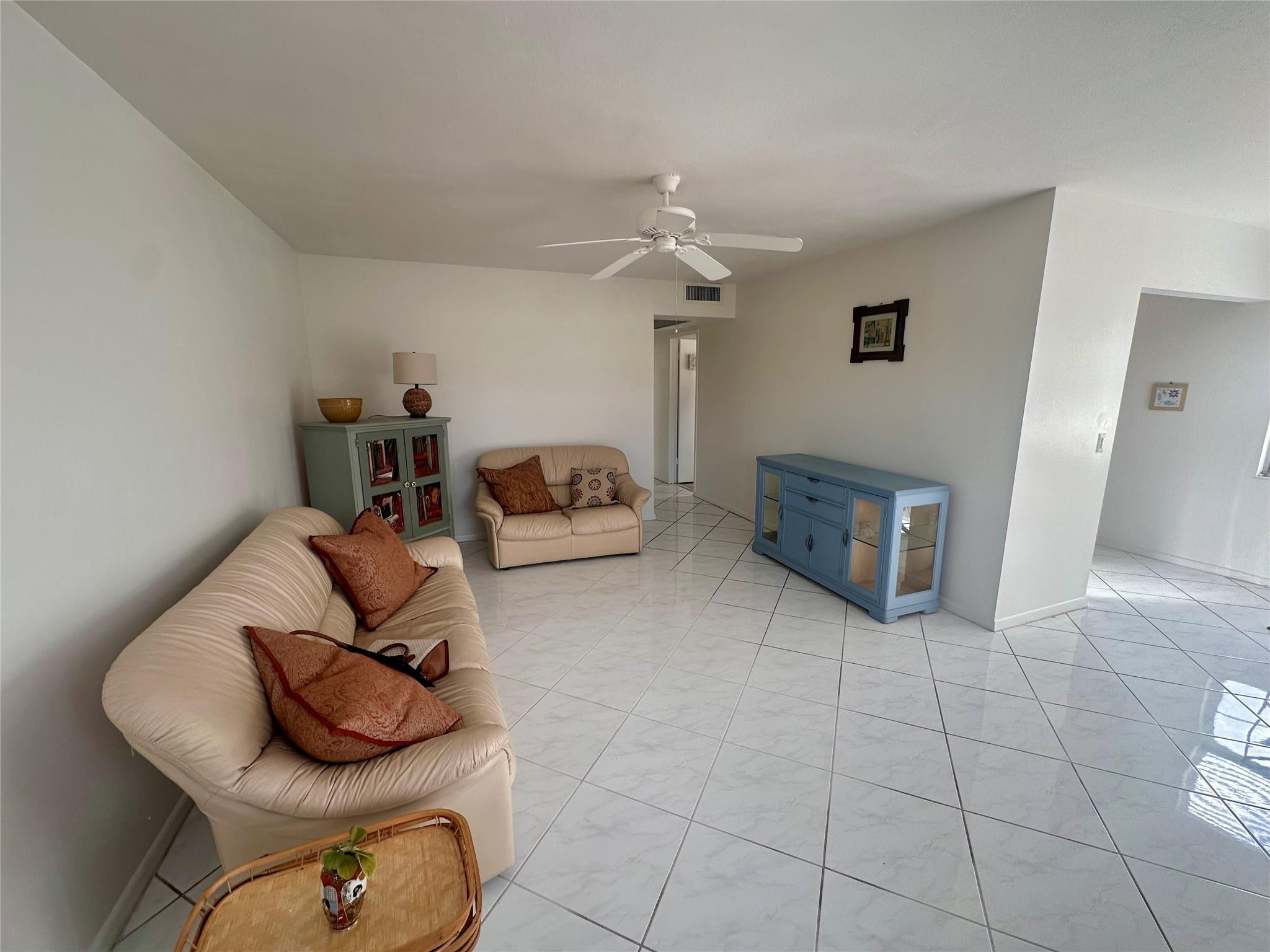 200 Mansfield F, Unit 200 Boca Raton, FL 33434 - Photo 6 of 15 a living room with furniture and a fireplace
