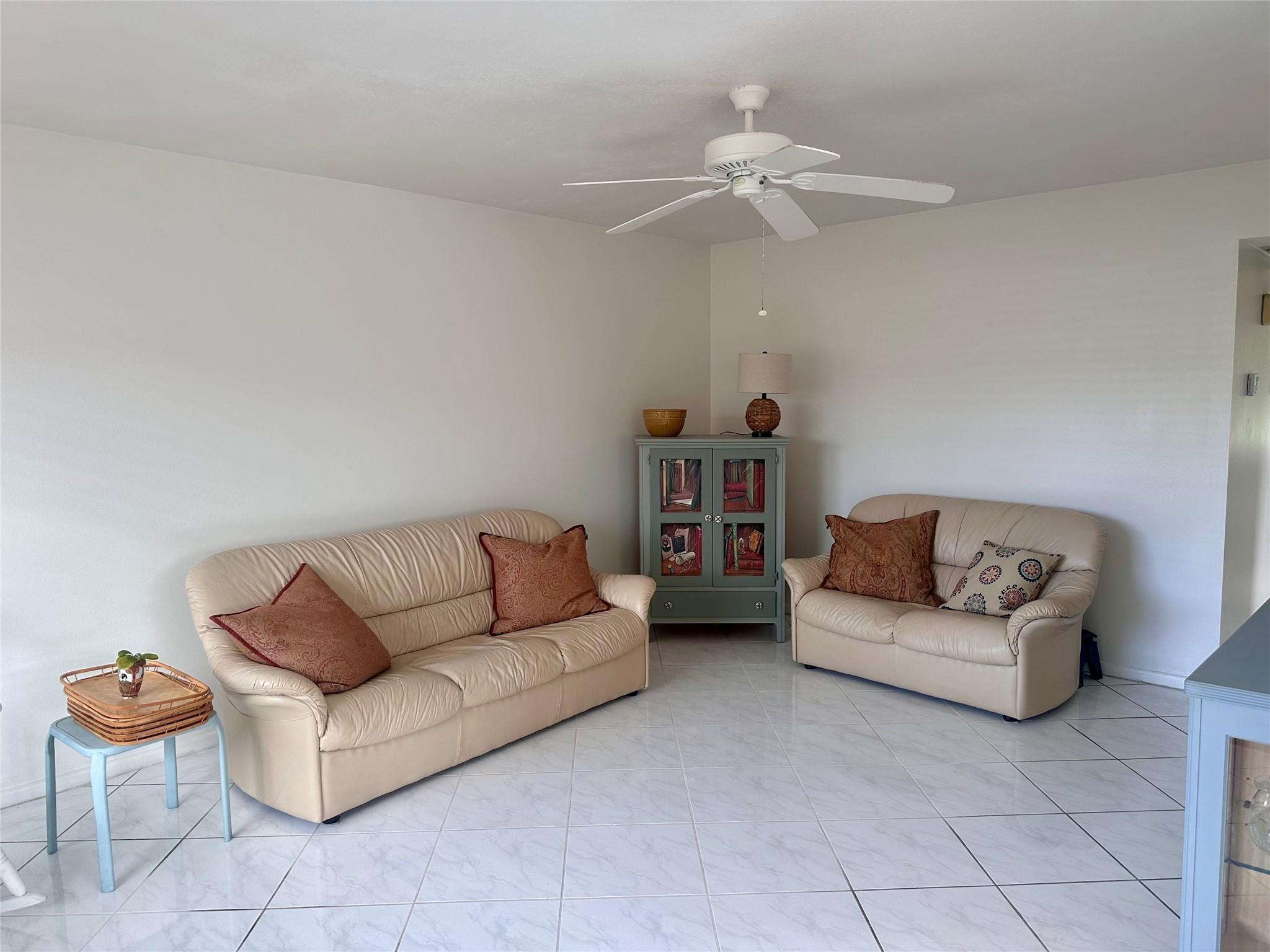 200 Mansfield F, Unit 200 Boca Raton, FL 33434 - Photo 7 of 15 a living room with furniture and a couch