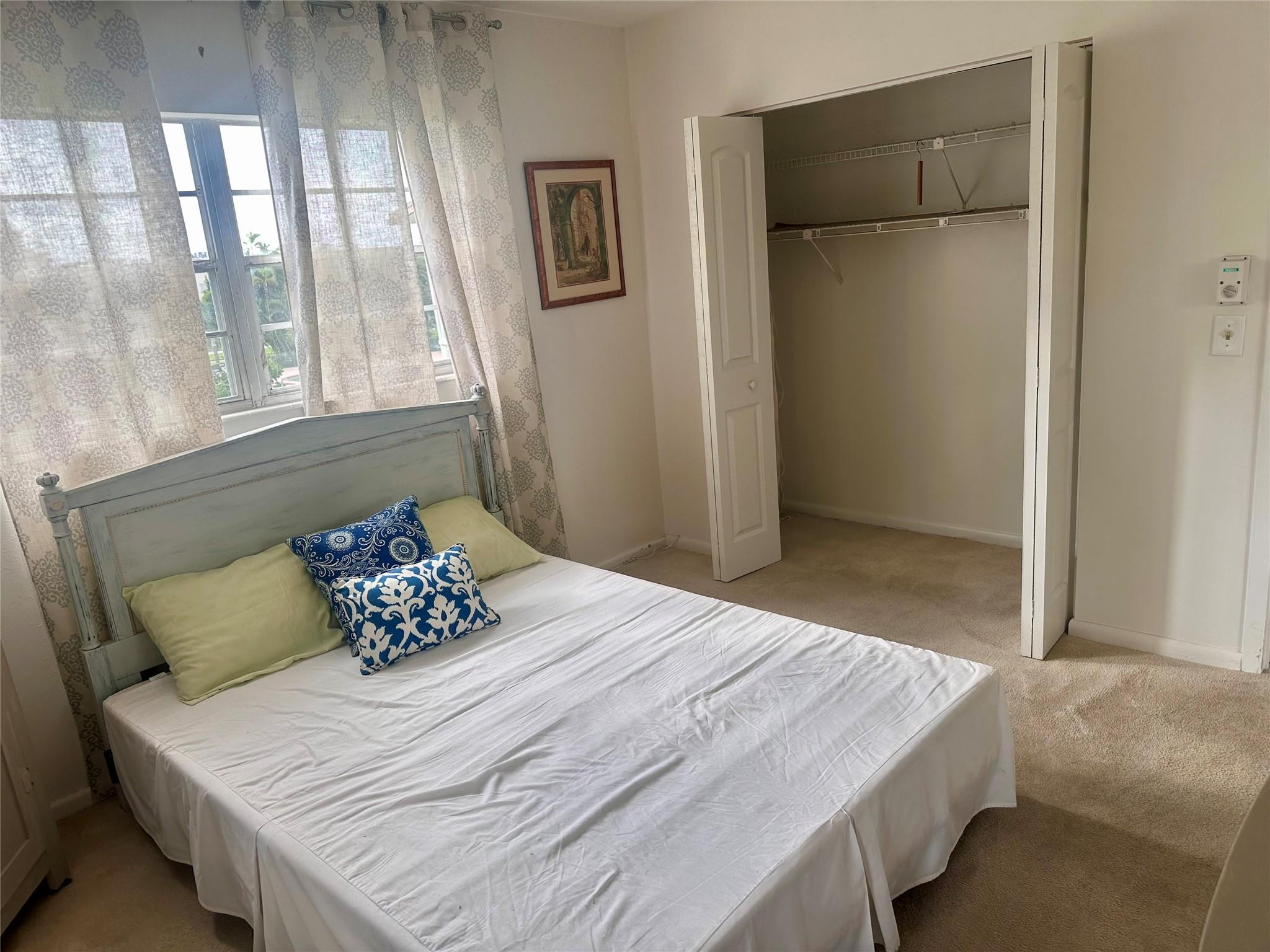 200 Mansfield F, Unit 200 Boca Raton, FL 33434 - Photo 10 of 15 a bedroom with a bed and a window