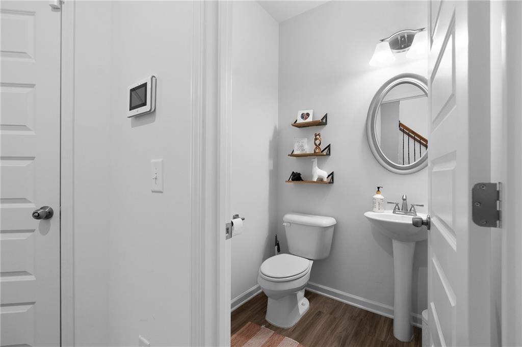 110 Waterside Ridgg Calhoun, GA 30701 - Photo 7 of 31 a white toilet sitting next to a bathroom sink and vanity