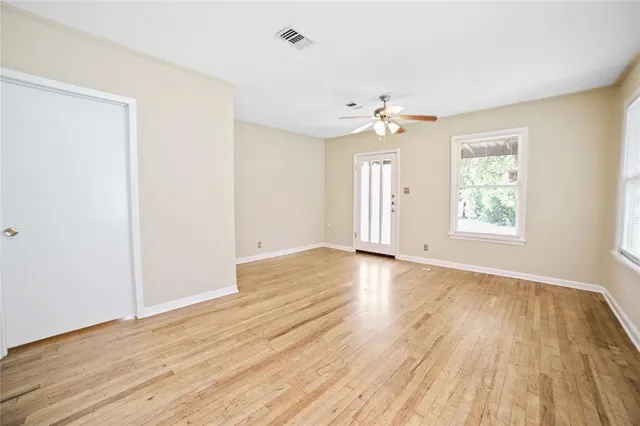 wooden floor in an empty room with a window