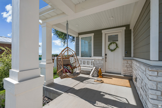 2706 West Maple Street, Unit 285 Mapleton, UT 84664 - Photo 4 of 36 Covered front porch featuring white columns and a light gray ceiling