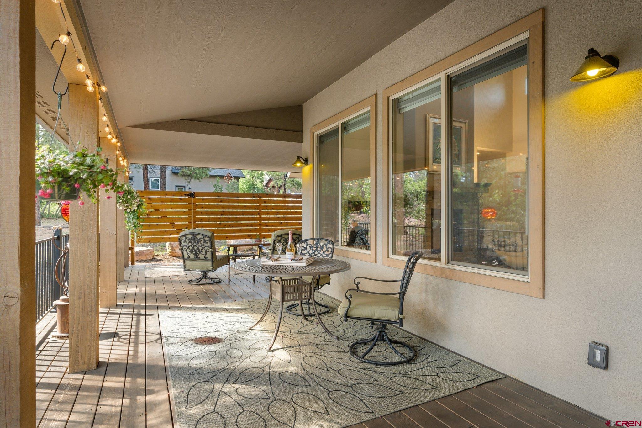 65 Needle Creek Trail Durango, CO 81301 - Photo 13 of 35 a living room with couches and a dining table with garden view