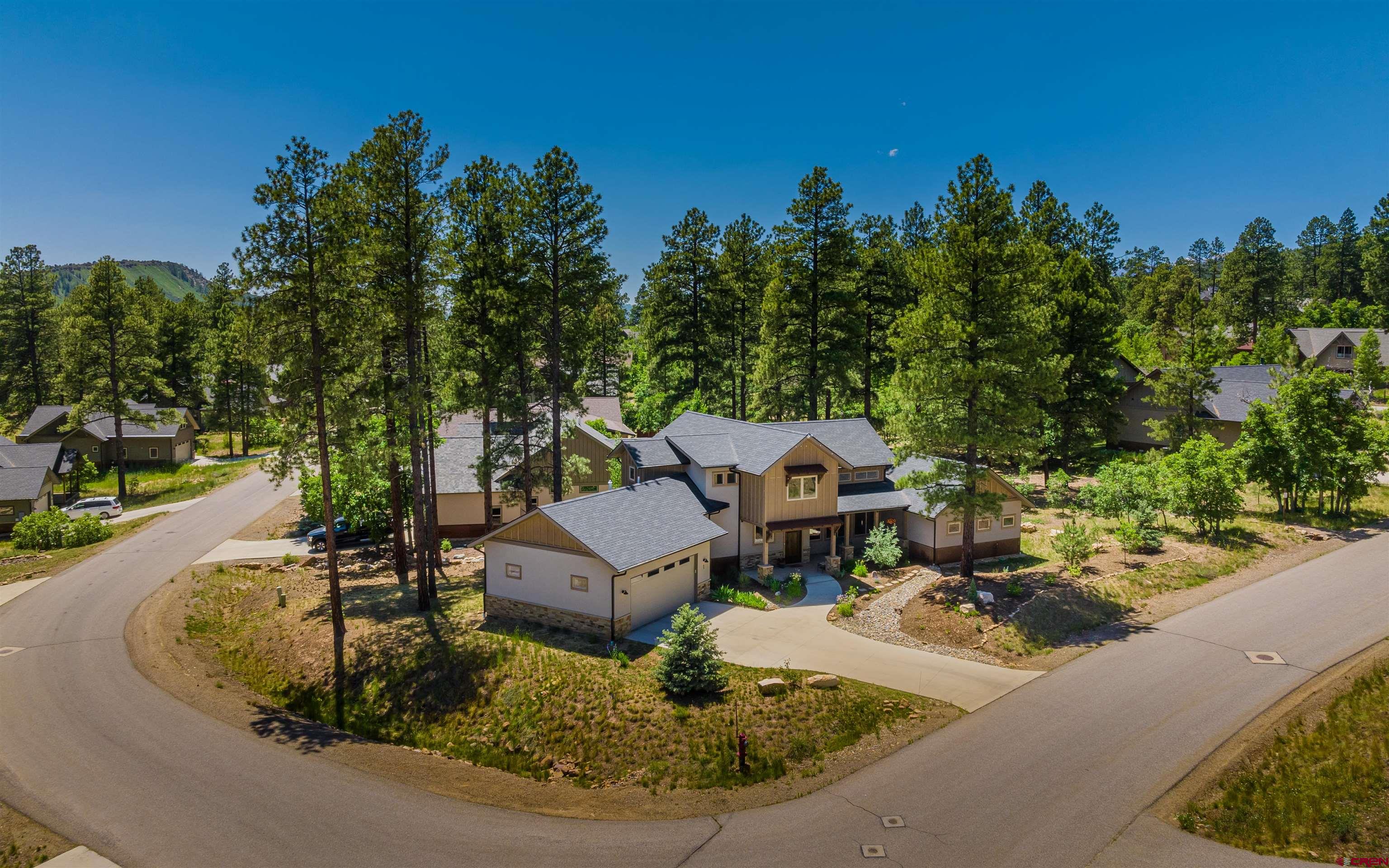65 Needle Creek Trail Durango, CO 81301 - Photo 25 of 35 an aerial view of a house with garden space and trees in the background