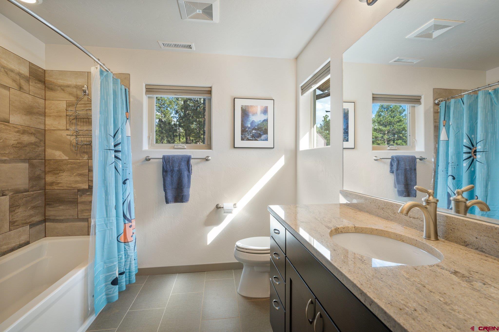 65 Needle Creek Trail Durango, CO 81301 - Photo 30 of 35 a bathroom with a granite countertop sink toilet and shower