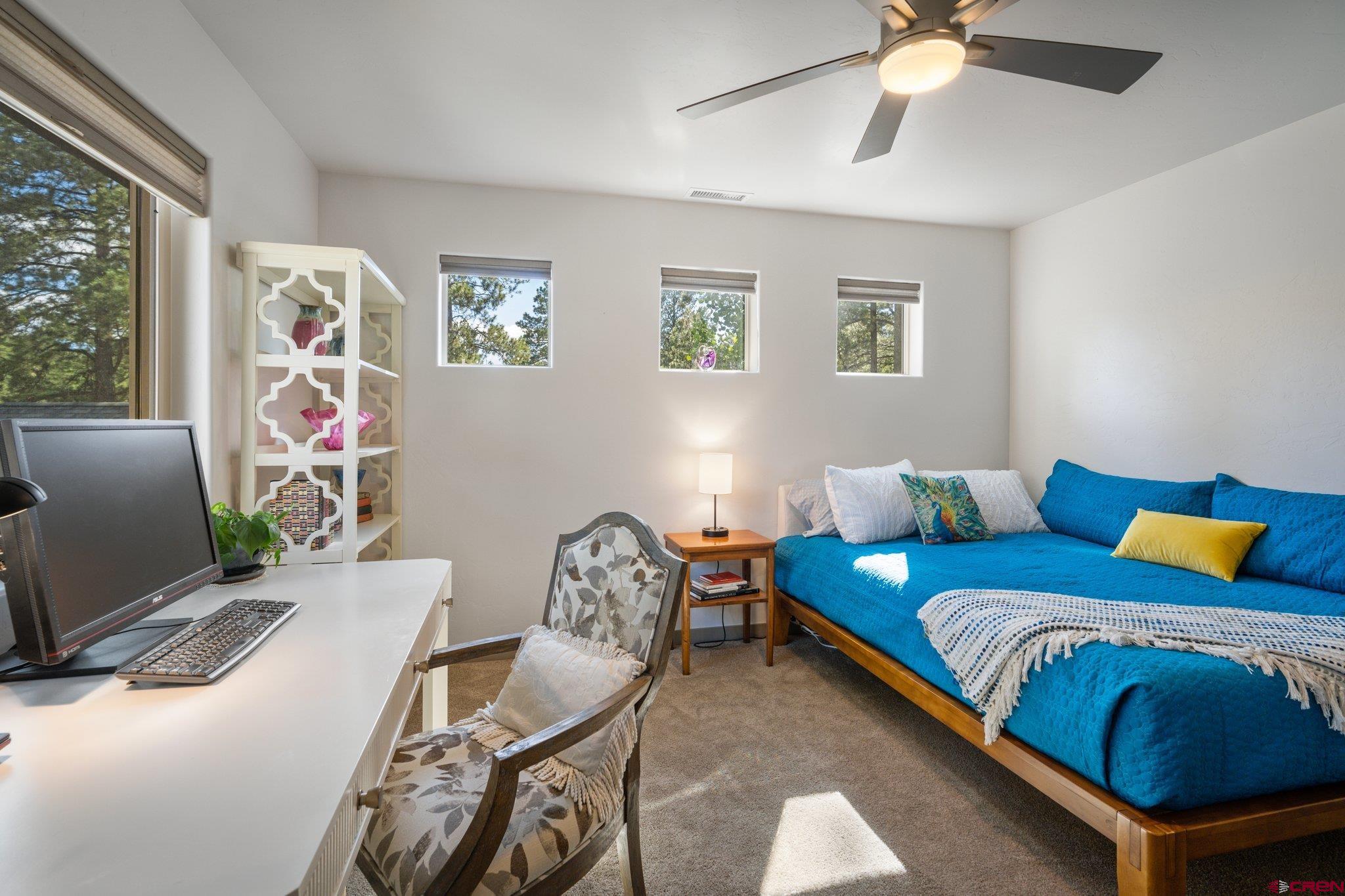 65 Needle Creek Trail Durango, CO 81301 - Photo 32 of 35 a bedroom with a bed and a chandelier