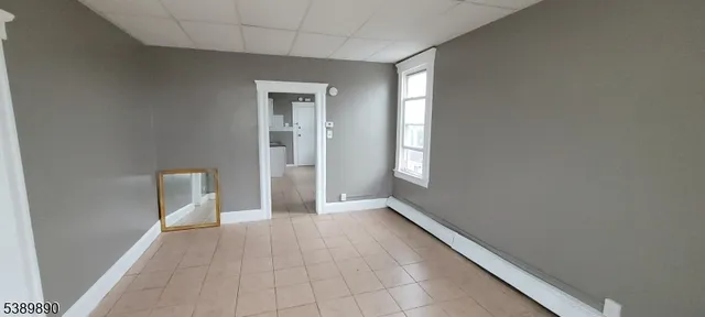 a view of a hallway with an empty room and a window