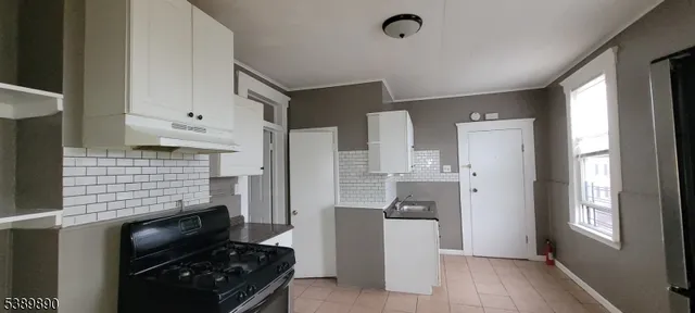 a kitchen with a refrigerator and a stove