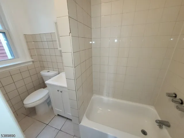 a white bath tub sitting next to a white toilet