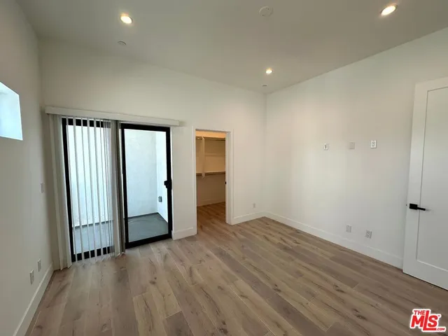 a view of hallway with wooden floor