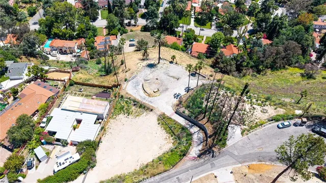 an aerial view of a house with a yard and lake view