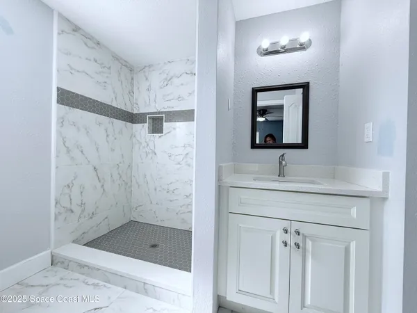 a bathroom with a toilet sink and shower
