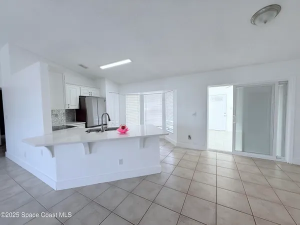 a view of kitchen with stainless steel appliances a sink and a counter top space