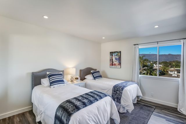 a bedroom with a bed and a refrigerator