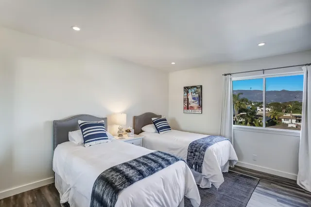 a bedroom with a bed and a refrigerator