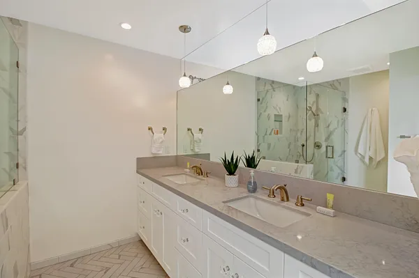a bathroom with a granite countertop sink toilet and shower