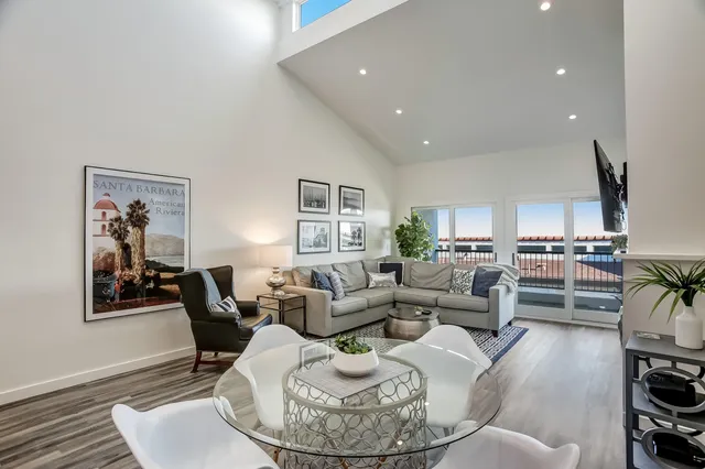 a living room with furniture kitchen and a table