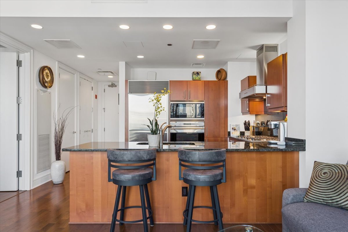 401 North Wabash Avenue, Unit 37I Chicago, IL 60611 - Photo 13 of 40 a kitchen with stainless steel appliances granite countertop a refrigerator a stove and a wooden cabinets