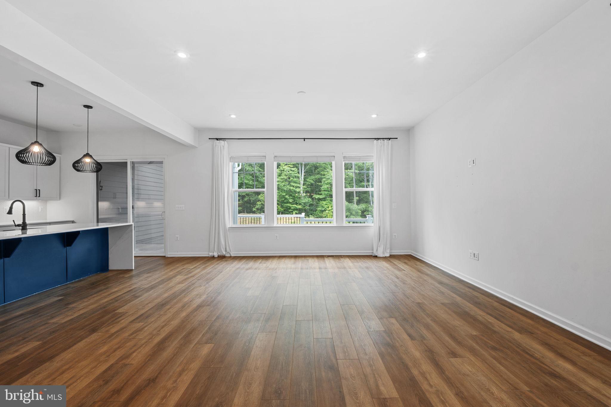 18080 Moss Garden Road Dumfries, VA 22026 - Photo 11 of 76 a view of an empty room with a window and wooden floor