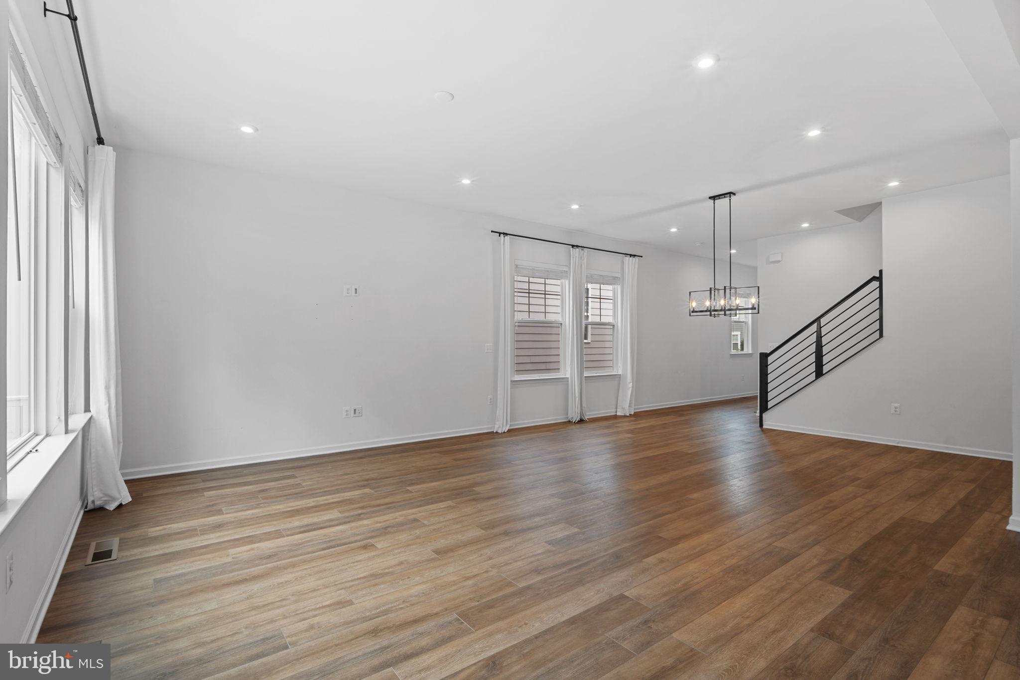18080 Moss Garden Road Dumfries, VA 22026 - Photo 13 of 76 an empty room with wooden floor and windows