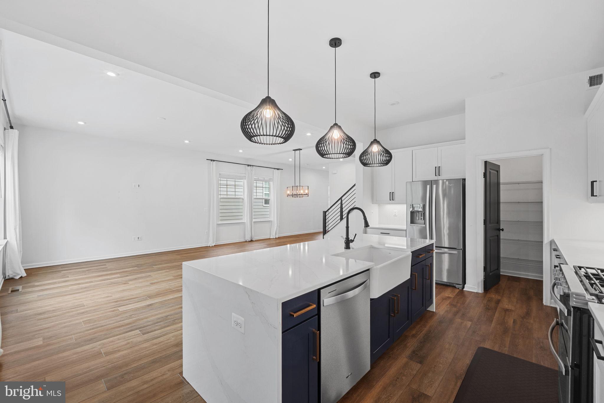 18080 Moss Garden Road Dumfries, VA 22026 - Photo 15 of 76 a large kitchen with stainless steel appliances a large center island attached withe living room